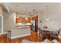 Bright kitchen featuring wooden cabinets, stainless steel appliances, and a granite countertop island at 10111 Inverness Main St # 312, Englewood, CO 80112