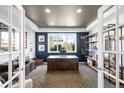 Bright and airy office featuring custom built-ins, a large desk, and plenty of natural light at 8390 Coyote Dr, Castle Pines, CO 80108