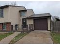Front view of the house with a one-car attached garage and front door access at 220 Mckinley Dr, Bennett, CO 80102