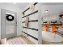 Welcoming foyer with stylish coat rack and view into a home office area at 9300 E Florida Ave # 1202, Denver, CO 80247