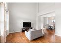 Bright and airy living room featuring hardwood floors and a soaring ceiling at 5604 S Shawnee St, Aurora, CO 80015