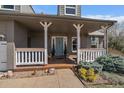 Inviting covered front porch with white railings and a swing, perfect for relaxing at 7356 S Miller Ct, Littleton, CO 80127