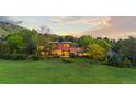 Elegant multi-story home boasting expansive windows, manicured landscaping, and a lush green lawn at 700 Utica Ave, Boulder, CO 80304