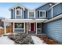 Close up on a brick house facade with red front door at 5395 S Flanders Way, Centennial, CO 80015