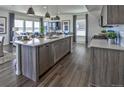 Bright, open kitchen featuring stainless appliances, a spacious island, and an open living area at 834 N Bently St, Watkins, CO 80137
