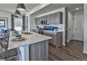 Kitchen featuring stainless appliances, bar seating, and wooden cabinets at 834 N Bently St, Watkins, CO 80137