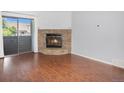 Spacious living room featuring a stone fireplace and sliding glass doors to the balcony at 3600 S Pierce St # 2-201, Lakewood, CO 80235