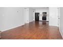 Open-concept room featuring wood floors and an easy flow to the kitchen at 3600 S Pierce St # 2-201, Lakewood, CO 80235