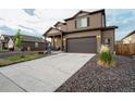 Two-story home showing a two-car garage, a concrete driveway, and easy-to-maintain landscaping at 2303 Monte Vista St, Fort Lupton, CO 80621