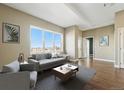 Bright living room boasts a large window with city views, hardwood floors, and modern decor at 1950 N Logan St # 1109, Denver, CO 80203