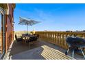Outdoor dining on roof deck with shade umbrella, stone balustrade, and city views at 1950 N Logan St # 1109, Denver, CO 80203