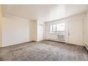 An empty bedroom features soft carpet, a closet, and a window for natural light, creating a calming space at 5995 W Hampden Ave # 8C, Denver, CO 80227