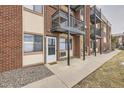 Apartment complex entrance featuring brick facade, private balconies and well-maintained grounds at 5995 W Hampden Ave # 8C, Denver, CO 80227