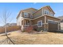 Charming home with a covered porch, a well-kept lawn, and a two-car garage, perfect for Gathering living at 3762 White Rose Loop, Castle Rock, CO 80108