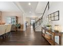 Inviting foyer with hardwood floors and staircase, showcasing an open concept design and stylish decor at 3762 White Rose Loop, Castle Rock, CO 80108