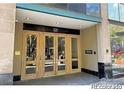 Close up of the main entrance with glass doors to the building numbered 720 at 720 16Th St # 513, Denver, CO 80202