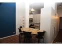 Open kitchen with granite countertops, stainless appliances, and adjacent breakfast bar at 720 16Th St # 513, Denver, CO 80202