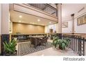 View of the lobby with seating, a reception desk and nice plants at 720 16Th St # 513, Denver, CO 80202