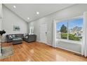 Inviting living room with hardwood floors, a vaulted ceiling, and large window, providing ample natural light at 19616 E Milan Cir, Aurora, CO 80013