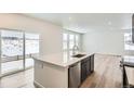 Kitchen island with sink, dishwasher, and view to backyard at 250 Paloma Way, Elizabeth, CO 80107