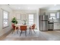 Charming dining area with modern table and chairs, bathed in natural light and open to the updated kitchen at 4325 S Cherokee St, Englewood, CO 80110