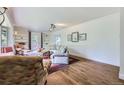 Comfortable living room featuring built-in shelving, hardwood flooring, and a large bay window at 6451 Crestbrook Dr, Morrison, CO 80465