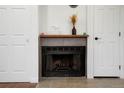Cozy fireplace with mantel, flanked by storage closets and doors at 8701 Huron St # 2-106, Thornton, CO 80260
