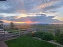 Inviting backyard with green lawn, garden, and scenic views, perfect for relaxing evenings at 2355 Saddle Back Ct, Fort Lupton, CO 80621