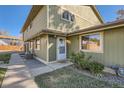 Charming townhome featuring light green siding and a well-maintained lawn leading to the front door on a sunny day at 1165 S Fairplay Cir # B, Aurora, CO 80012