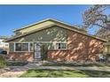 Inviting home featuring a mix of siding and brick, complemented by a well-kept lawn, on a sunny day at 1165 S Fairplay Cir # B, Aurora, CO 80012