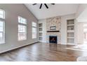Bright living room with vaulted ceiling, fireplace, and hardwood floors at 5597 S Buchanan St, Aurora, CO 80016