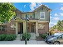 Inviting two-story townhome with brick and stucco exterior on a sunny day at 701 N Roslyn St # 36, Denver, CO 80230