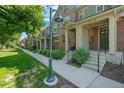 Street view of attractive townhomes with well-maintained landscaping and walkways at 701 N Roslyn St # 36, Denver, CO 80230