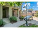Charming townhome entrance with landscaped walkway and garden at 701 N Roslyn St # 36, Denver, CO 80230