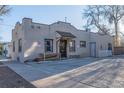 Commercial building with neutral stucco, providing private parking, benches, and classic lighting at 2606 W Alamo Ave, Littleton, CO 80120