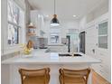 Bright kitchen featuring white cabinetry, quartz countertops, and modern fixtures at 288 S Sherman St, Denver, CO 80209