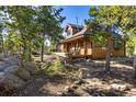 Inviting exterior with a spacious porch, ideal for relaxing and enjoying the serene, wooded surroundings at 44 Linn Ln, Golden, CO 80403