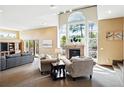Bright living room featuring a fireplace, large windows, and comfortable seating arrangements at 19640 Four Winds Way, Monument, CO 80132