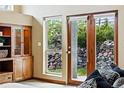 Living room featuring a view to the outside with doors to a stone covered patio at 19640 Four Winds Way, Monument, CO 80132