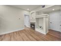 Living room featuring a fireplace with decorative mantle and wood-look flooring at 9590 E Florida Ave # 1025, Denver, CO 80247