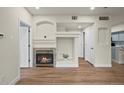 Living room view with a fireplace, mantel, and open doorway to other rooms at 9590 E Florida Ave # 1025, Denver, CO 80247