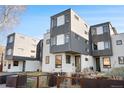 Striking contemporary home design with a unique gray and white facade, and minimalist landscaping at 1930 W 35Th Ave, Denver, CO 80211