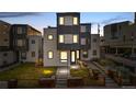 Modern home boasts a unique facade, a well-kept lawn, and landscaped garden beds at 1930 W 35Th Ave, Denver, CO 80211