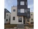 Modern home with a combination of gray and white finishes with inviting front walkway and yard at 1930 W 35Th Ave, Denver, CO 80211