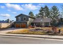 Attractive home with a two-car garage, complemented by a stone-accented front yard, showcasing curb appeal at 4468 S Zenobia St, Denver, CO 80236