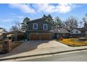 Inviting two-story residence with a spacious driveway and charming front yard landscaping, nestled in a quiet neighborhood at 4468 S Zenobia St, Denver, CO 80236