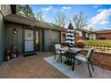 Cozy outdoor patio area with a table and chairs, perfect for relaxing and entertaining, showcasing a tranquil setting at 4468 S Zenobia St, Denver, CO 80236