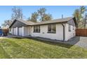 Well-maintained home with a lush green lawn and updated exterior paint at 5780 W 5Th Ave, Lakewood, CO 80226