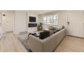 Bright living room with modern fireplace, sleek furniture, and hardwood floors at 5780 W 5Th Ave, Lakewood, CO 80226