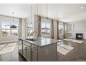 Open-concept kitchen flows into the living room with hardwood floors and recessed lighting at 10659 Montecito Dr, Lone Tree, CO 80124